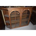 A stripped part glazed dresser back with canted shelf section