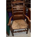 A traditional stained frame, Lancashire or similar spindle back carver chair having rush seat