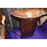 An early 20th Century oak demi lune hall table with cupboard section under, width approx. 76cm