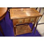 A modern hardwood side table, having deep frieze drawer, lined with script referring to Mr Baker's