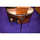 A reproduction mahogany demi lune hall table on cabriole legs, width approx. 74cm