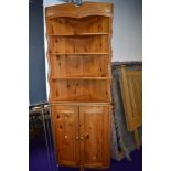 A vintage pine corner sehelf with cupboard under