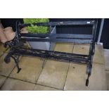 A traditional cast garden bench, wooden slats in disrepair