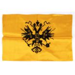 A small zarist flag silk, cotton 29x44 cm A hand embroidered cotton double head eagle on yellow silk
