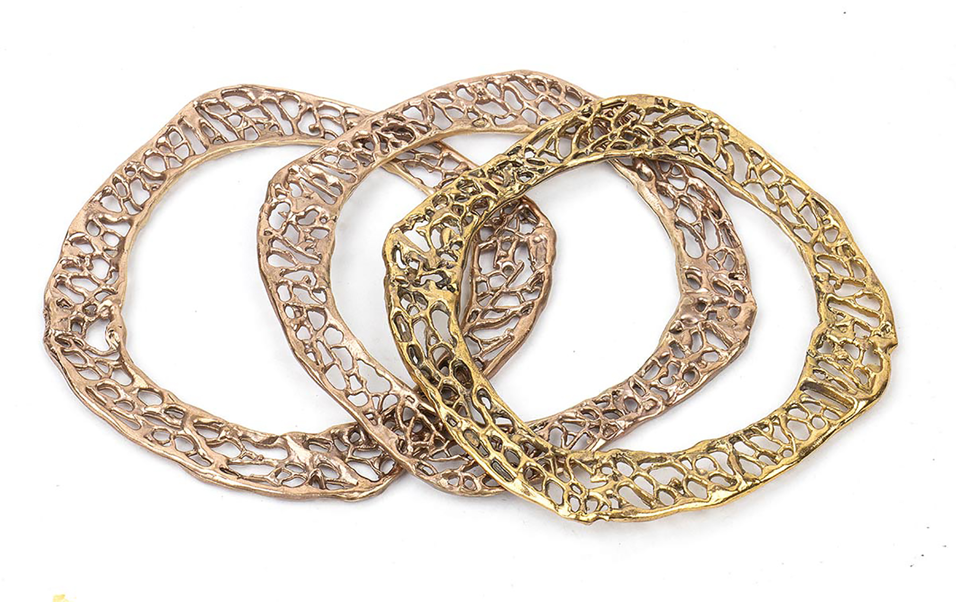 THREE BRONZE BRACELETS WITH YELLOW AND PINK 18 KT GOLD PLATING The cast bronze element represents