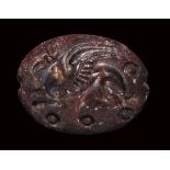 A mycenaean red jasper engraved seal. Griffin.