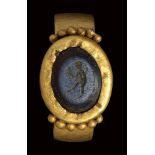 A roman nicolo intaglio set in an ancient gold ring. Faun.