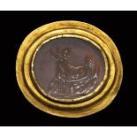 A roman chalcedony intaglio set in an ancient gold ring. Erotic scene.