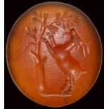 A roman carnelian intaglio. A goat under a tree.