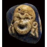 A roman fragment two-layers blue and white glass cameo. Theatrical mask.