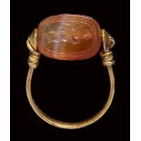 An etruscan agate scarab intaglio, mounted on an ancient gold ring. Hermes.