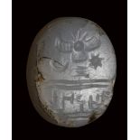 A semitic (paleo-hebrew) chalcedony scaraboid stamp-seal. Winged solar-disc and inscriptions.