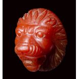 A fine roman carnelian applique-cameo. Frontal head of a lion.