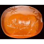 A roman carnelian intaglio. Bull with a star.