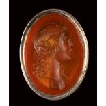 A neoclassical carnelian intaglio mounted on a seal. Bust of Apollo with lyre.