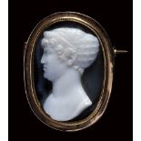 A late Georgian gold brooch set with an onyx cameo portrait by Berini. Bust of a noblewoman.