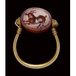 An etruscan carnelian scarab mounted on an ancient gold ring. Antelope.