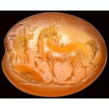 A roman carnelian intaglio. Horse with military trophy.