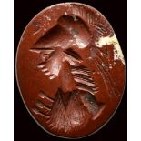 A roman red jasper intaglio. Bust of Athena.
