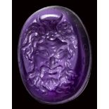 A fine renaissance amethyst intaglio. Mask of Pan with motto