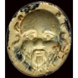 A roman burnt agate intaglio. Mask of Silenus.