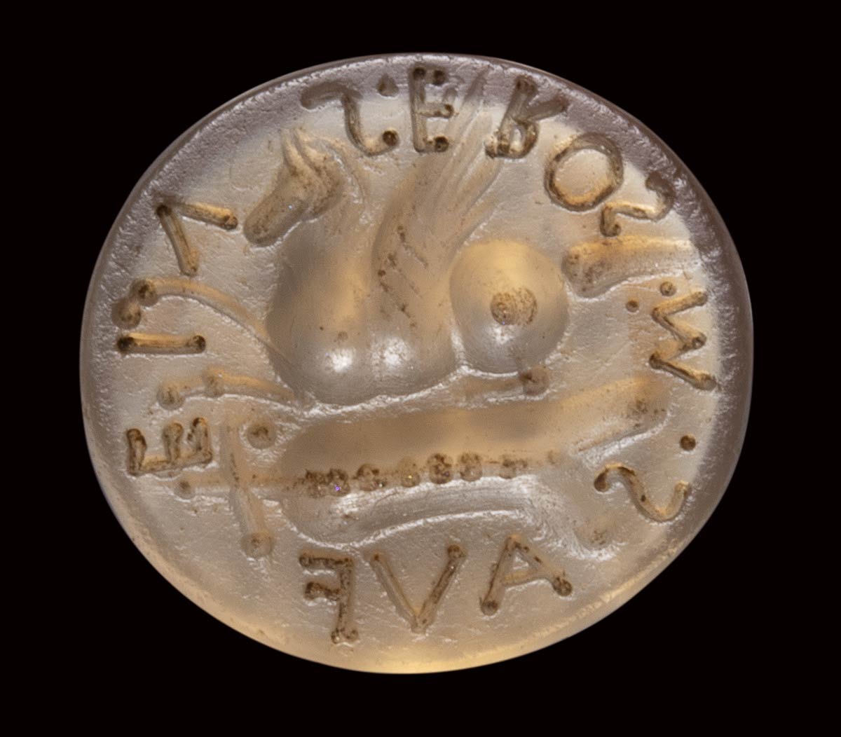 A roman italic chalcedony intaglio. Pegasus with inscription and allegorical attributes.