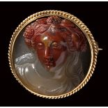 A fine neoclassical agate-chalcedony cameo mounted on a modern gold brooch. Bust of a Bacchante.