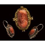 A Victorian red coral cameo set in a gold brooch with two small coral cameo set in earrings.