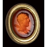 A fine roman carnelian intaglio set in a gold frame. Bust of Hercules.