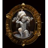 A very fine agate cameo by G.A. Girardet, set in a gold brooch. Eros with a Panoplia.