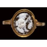 A roman burnt agate cameo mounted in a gold ring. Mythological scene.