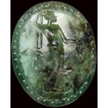 A rare roman emerald intaglio. Artemis with a magical inscription.