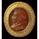 A carnelian cameo mounted in a gold brooch. Bust of a Saint Anthony of Padua.