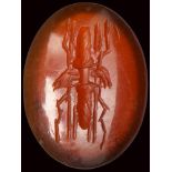 A roman deep red carnelian intaglio. Winged thunderbolt.