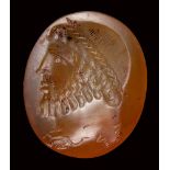 A large eastern roman carnelian intaglio. Bearded male bust with astrological symbols.