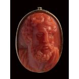 A fine neoclassical coral cameo set in a metal brooch. Bust of a bearded philosopher.