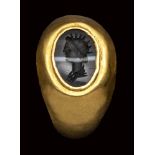 A roman banded agate intaglio set in ancient gold ring. Bust of Helios.