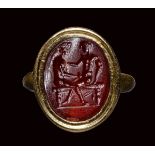 A roman carnelian intaglio mounted in a modern gold ring. Erotic scene.