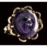 A fine roman amethyst cameo mounted on a modern gold ring. Mask of Bacchus.
