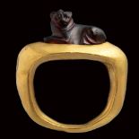 A fine greek garnet microsculpture mounted on a modern gold ring. Lioness.