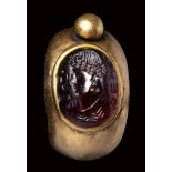 A North-West Indian gold ring with garnet intaglio. Bust of man with inscriptions.