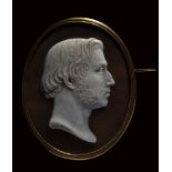 A 18K gold brooch set with a shell cameo signed JB Martin. Male portrait.