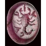 A roman republican garnet intaglio. Scorpio with letters.