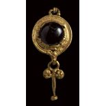 A roman gold and garnet earring with disc and pendant.