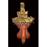 A gold and coral roman apotropaic phallic pendant.