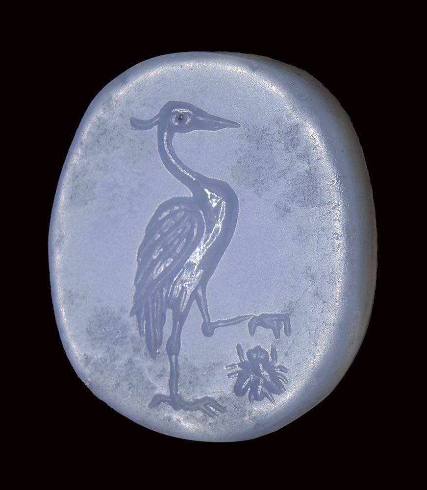 A fine greek blue chalcedony double sided seal intaglio. Heron hunting an insect / hazelnut.