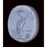 A fine greek blue chalcedony double sided seal intaglio. Heron hunting an insect / hazelnut.