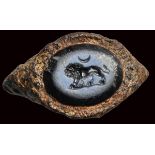 A roman nicolo intaglio set in an ancient iron fragmentary ring. Lion with crescent moon.