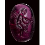 A roman republican garnet intaglio. Eros with a bow.