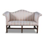 A GEORGE III MAHOGANY FRAMED CAMEL BACK UPHOLSTERED TWO SEATER SETTEE, raised on chamfered square